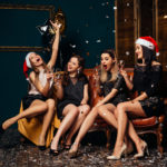 Found glamorous women drinking champagne at Christmas party