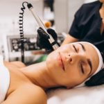 Woman receiving facial beauty treatment